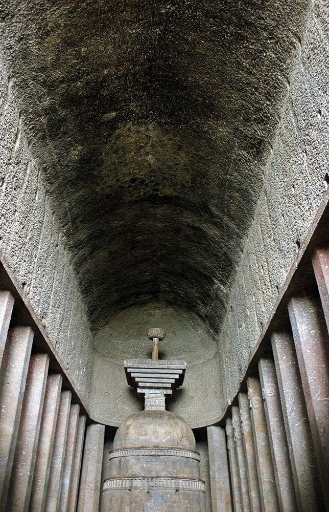 Ceiling in Bedse Caves is bare, without adornment. Five columns with ornaments are visible